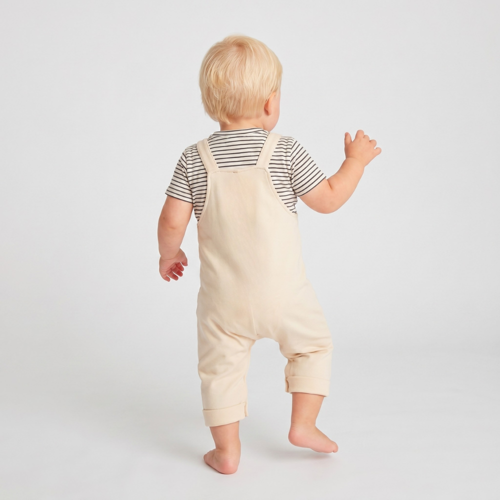 Baby dungarees with playful 3D dinosaur print
